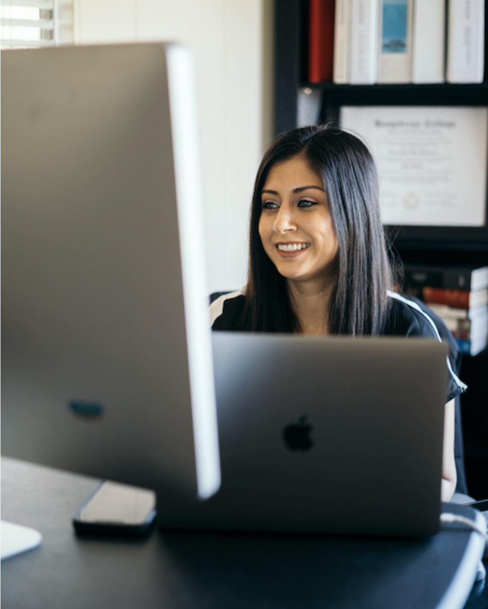 Kerren Archuleta working at her desk