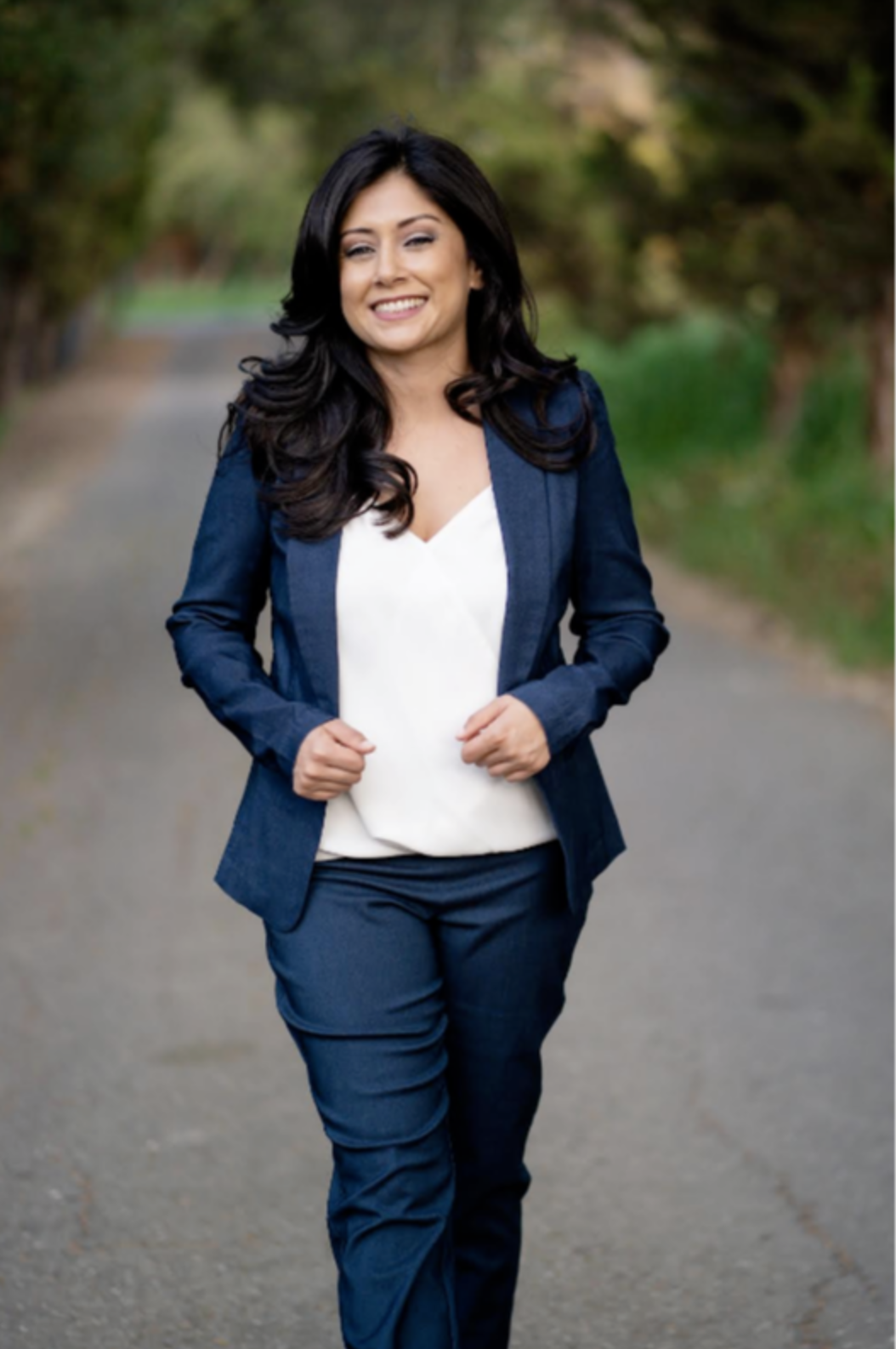 Kerren Archuleta walking outdoors in a blue suit